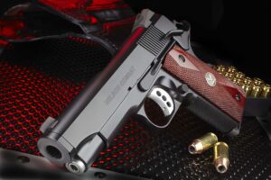 Wilson Combat Stealth .45 ACP black pistol with checkered cocobolo grips and tritium night sights